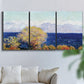 Three-panel canvas wall art featuring mediterranean coastline with headland, displayed in a living room above a sofa.