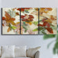 Three-panel canvas wall art featuring layered floral botanical impressions, displayed in a living room above a sofa.