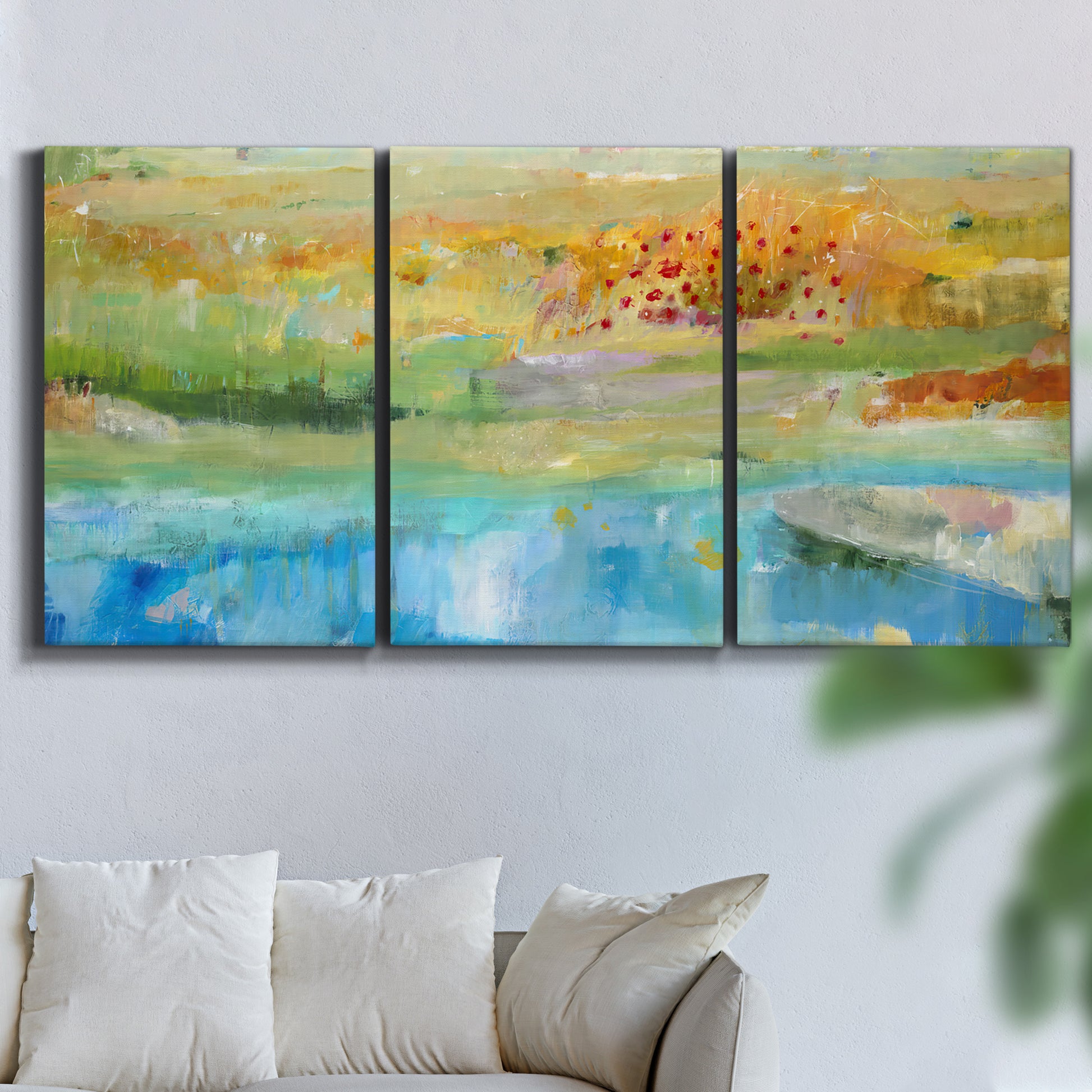 Three-panel canvas wall art featuring abstract sense of forward movement, displayed in a living room above a sofa.