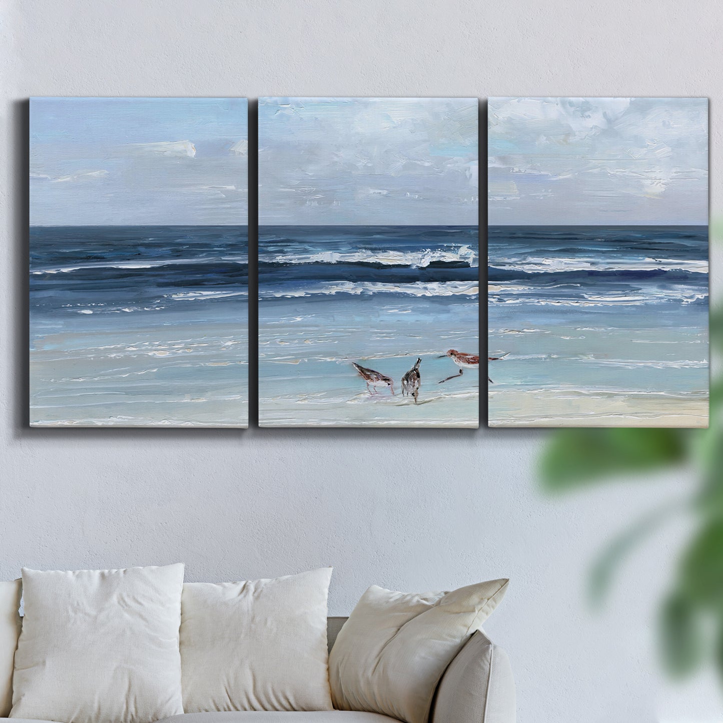 Three-panel canvas wall art featuring loose farmhouse style floral painting, displayed in a living room above a sofa.