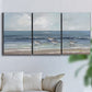 Three-panel canvas wall art featuring shore birds searching along beach, displayed in a living room above a sofa.
