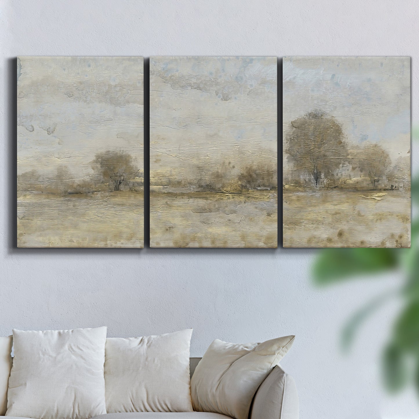 Three-panel canvas wall art featuring late season rural harvest fields, displayed in a living room above a sofa.