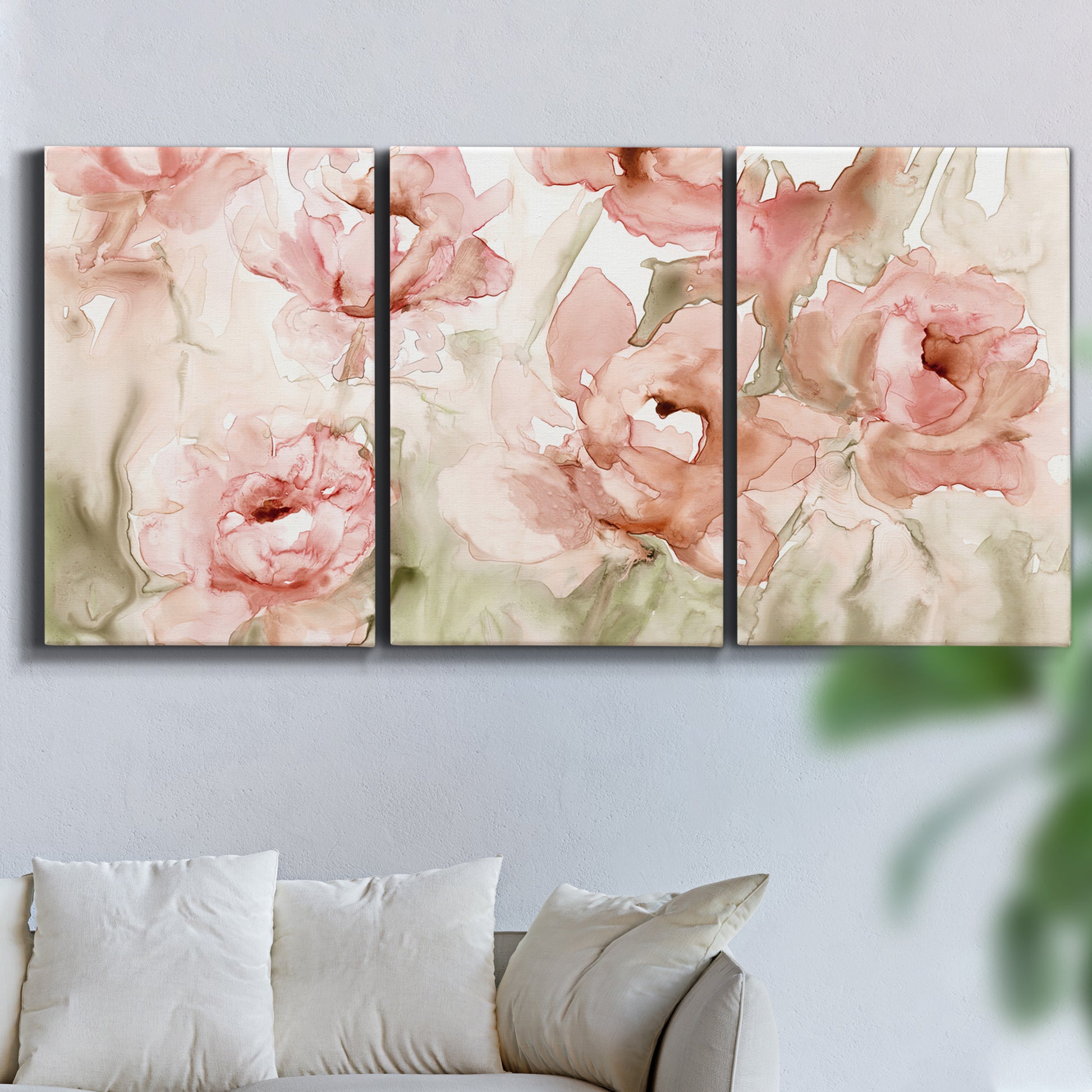 Three-panel canvas wall art featuring spring floral blossoms in bloom, displayed in a living room above a sofa.