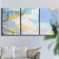 Three-panel canvas wall art featuring soft abstract spring watercolor tones, displayed in a living room above a sofa.