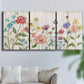 Three-panel canvas wall art featuring delicate wildflower illustration, displayed in a living room above a sofa.
