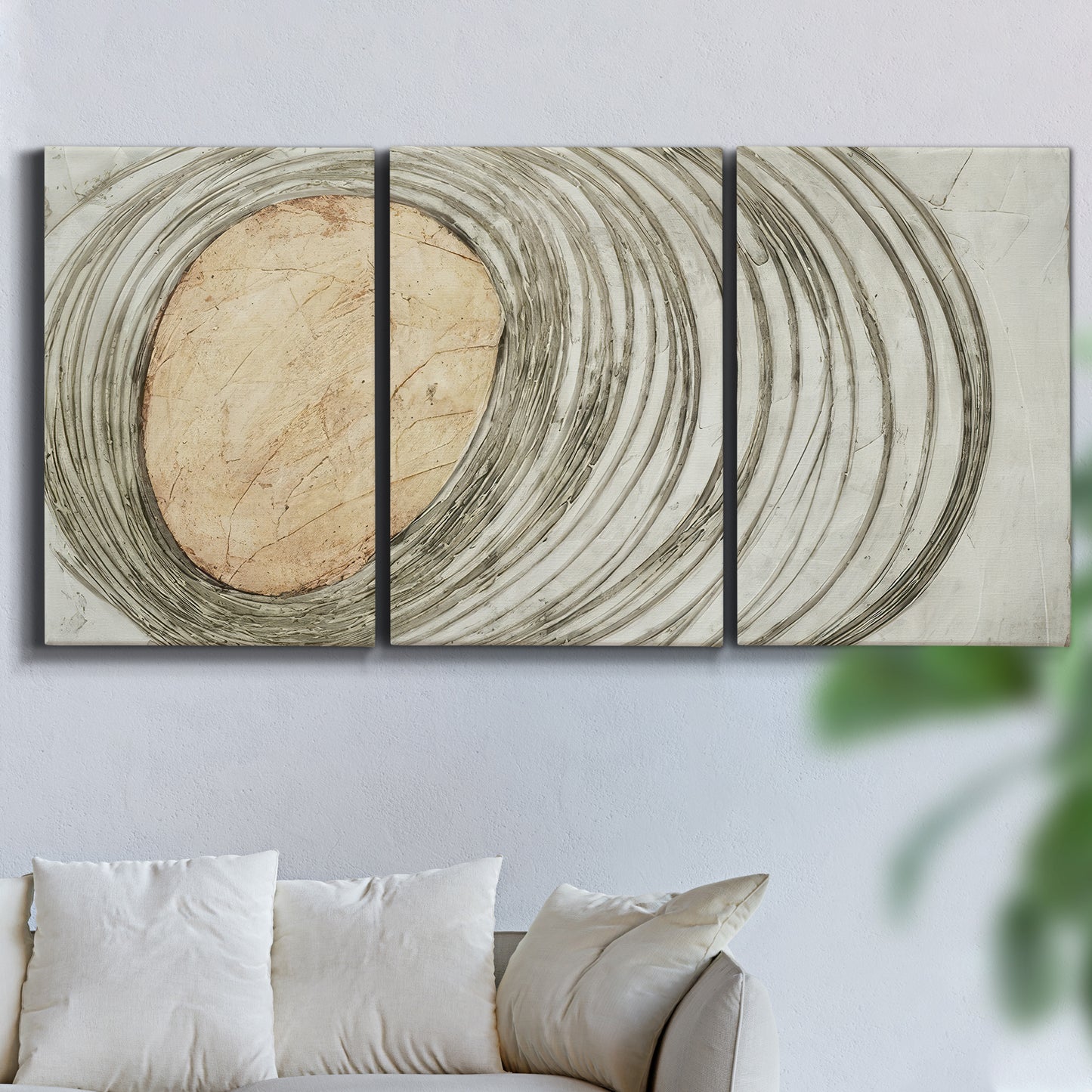 Three-panel canvas wall art featuring circular abstract energy forms, displayed in a living room above a sofa.