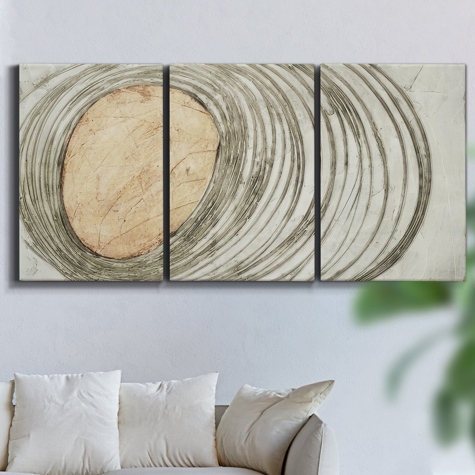 Three-panel canvas wall art featuring circular abstract energy forms, displayed in a living room above a sofa.
