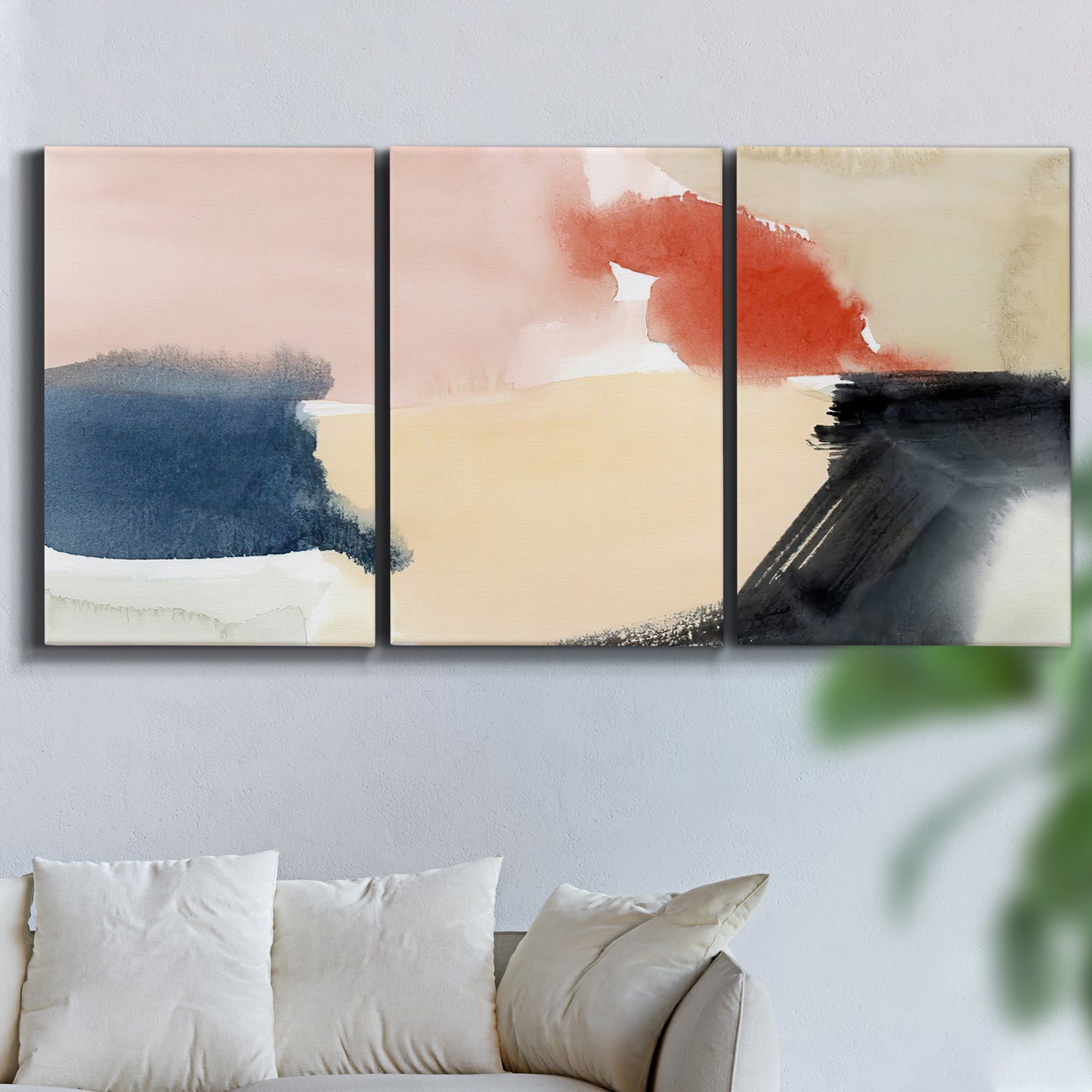 Three-panel canvas wall art featuring playful abstract watercolor shapes, displayed in a living room above a sofa.