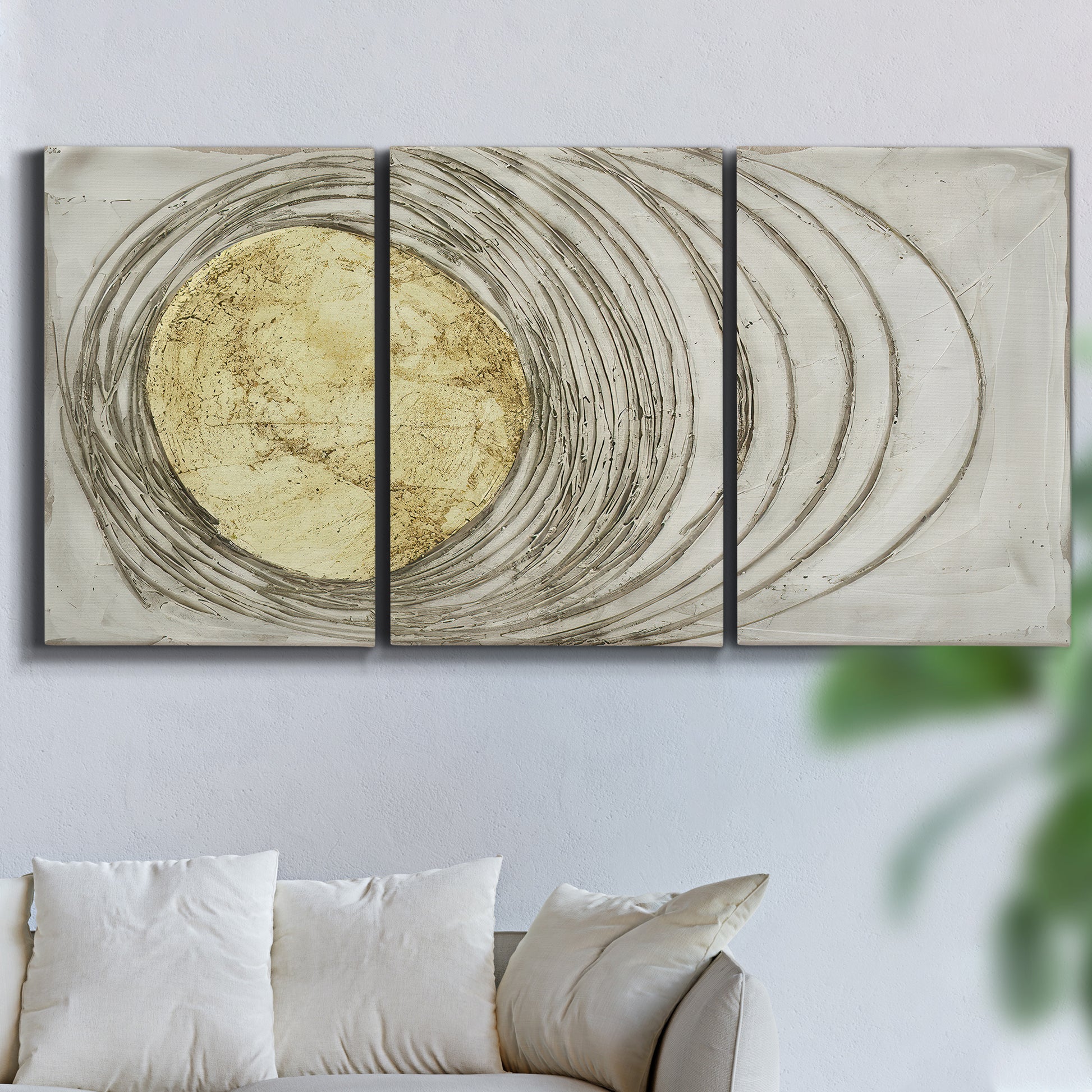Three-panel canvas wall art featuring circular abstract energy forms, displayed in a living room above a sofa.