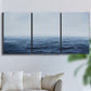 Three-panel canvas wall art featuring grayscale seascape with horizon, displayed in a living room above a sofa.