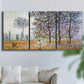 Three-panel canvas wall art featuring three poplar trees beside water, displayed in a living room above a sofa.