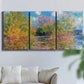 Three-panel canvas wall art featuring wide river landscape, displayed in a living room above a sofa.