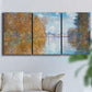 Three-panel canvas wall art featuring autumn landscape with glowing foliage, displayed in a living room above a sofa.