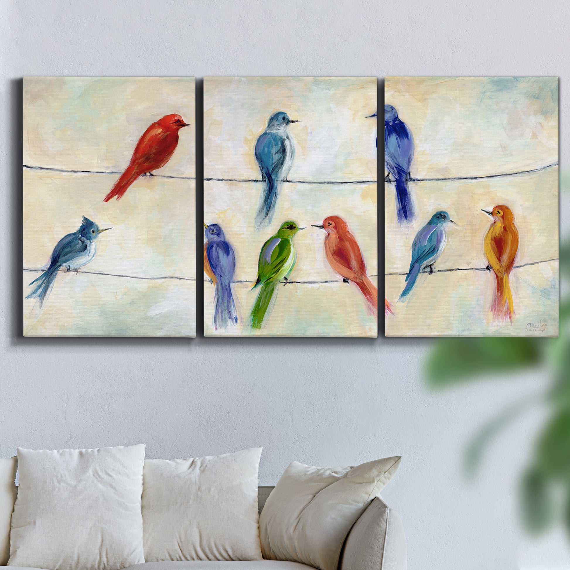 Three-panel canvas wall art featuring whimsical animal chatter illustration, displayed in a living room above a sofa.