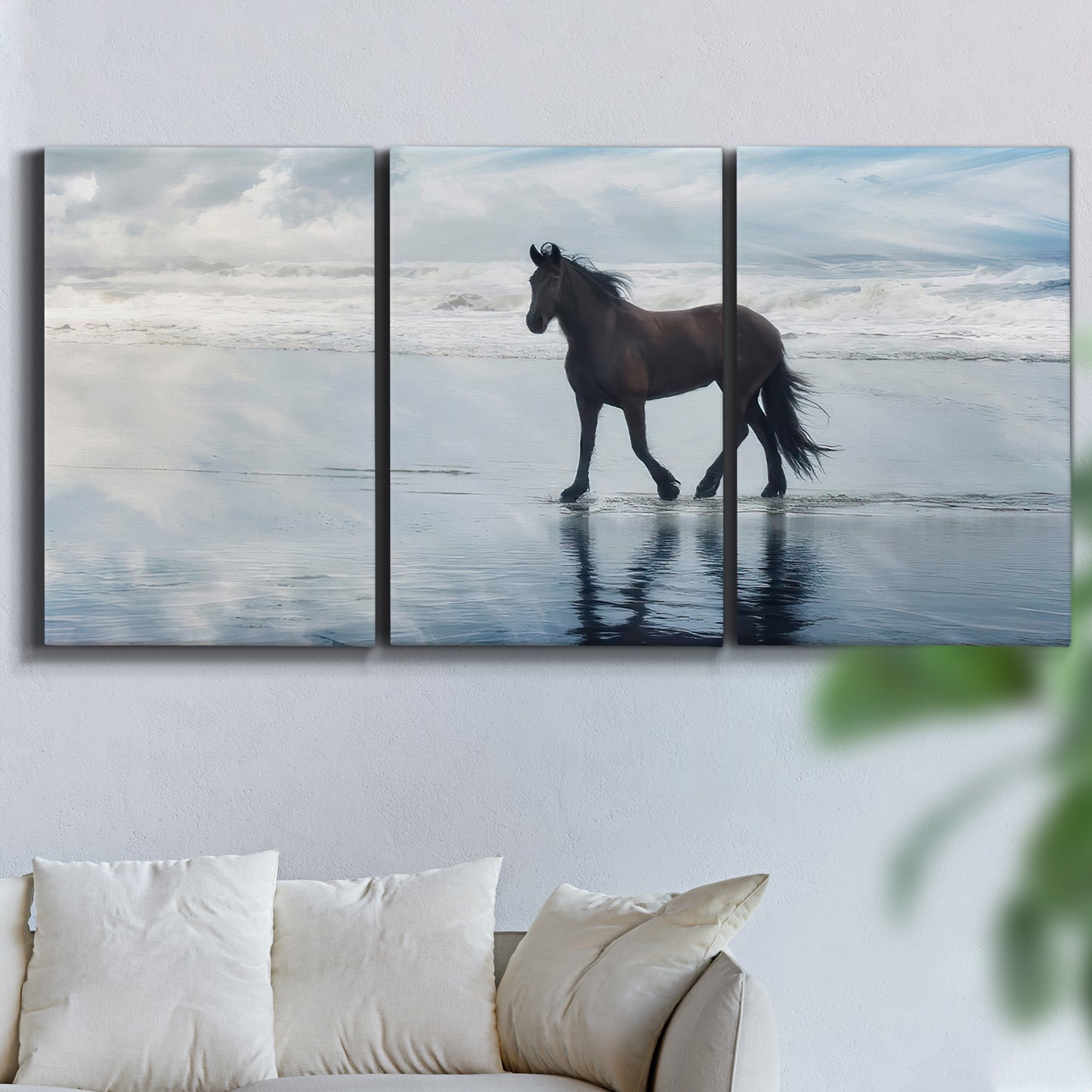Three-panel canvas wall art featuring running horses captured mid stride, displayed in a living room above a sofa.