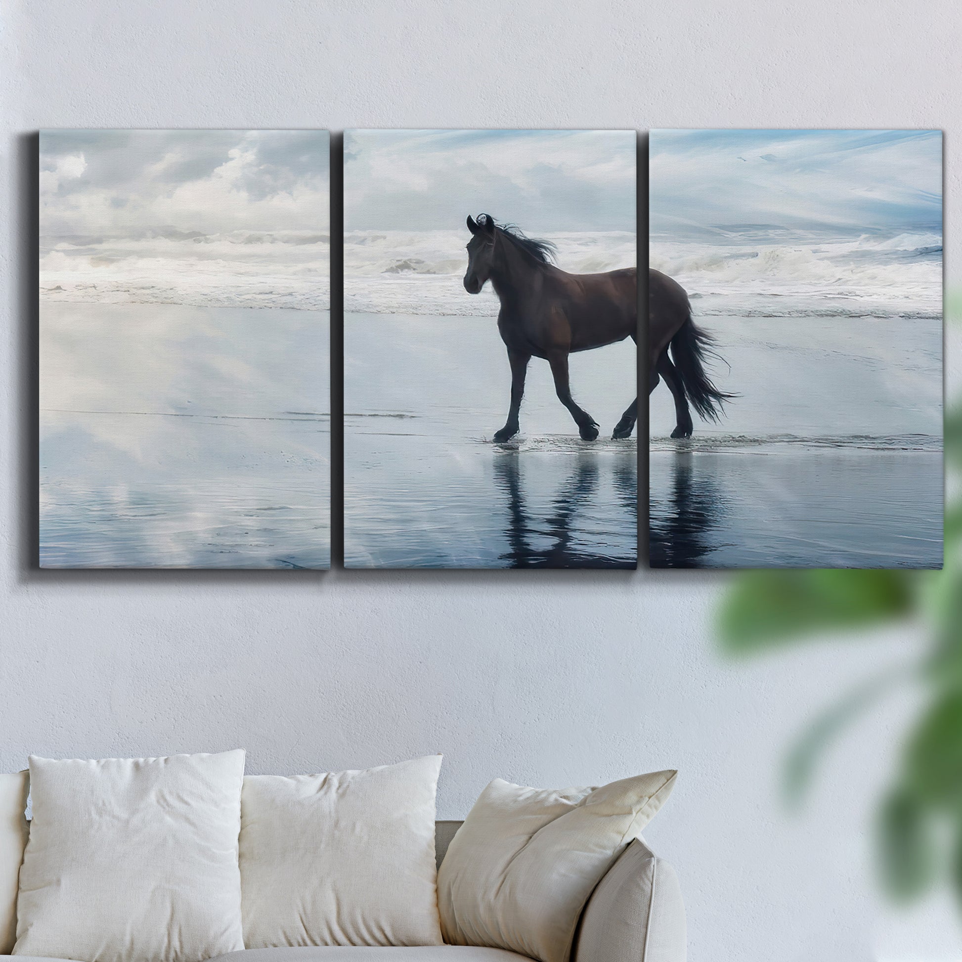 Three-panel canvas wall art featuring running horses captured mid stride, displayed in a living room above a sofa.
