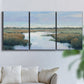 Three-panel canvas wall art featuring coastal plain with layered horizon, displayed in a living room above a sofa.