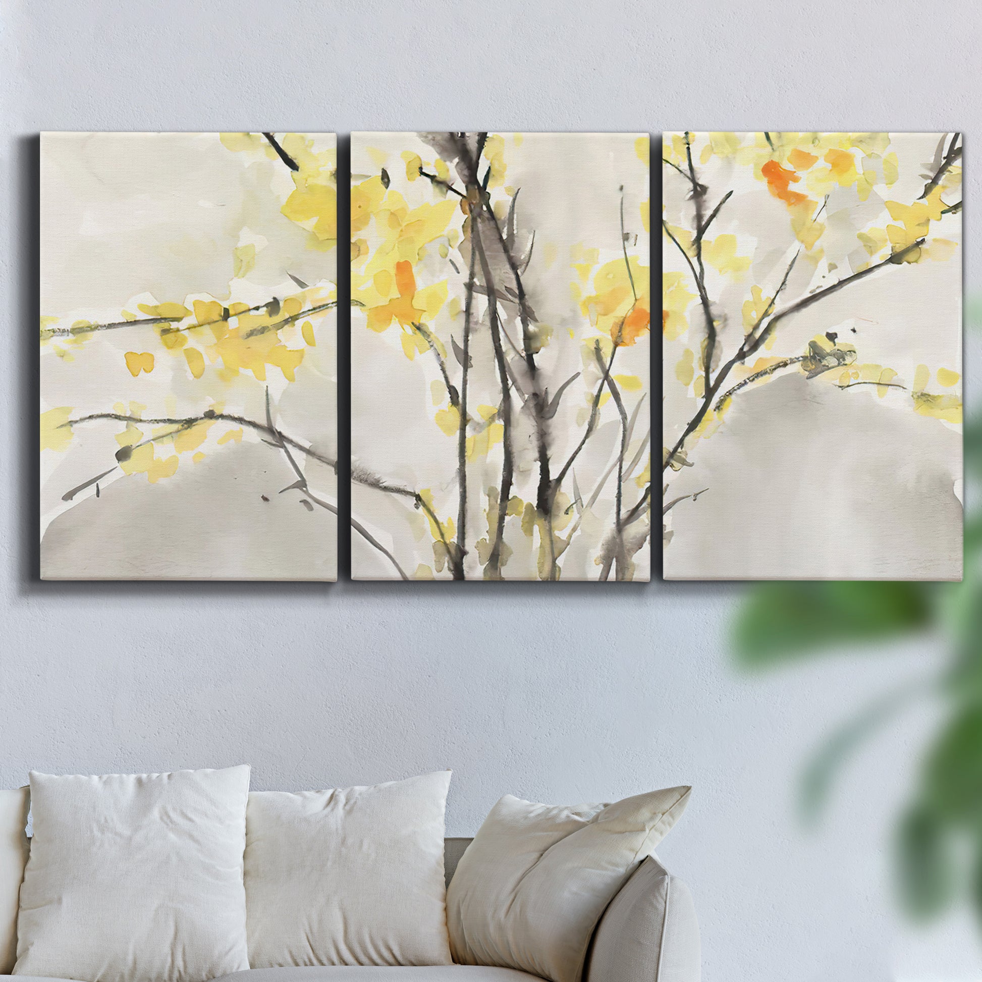 Three-panel canvas wall art featuring soft floral abstract harmony, displayed in a living room above a sofa.
