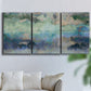 Three-panel canvas wall art featuring cool dreamy abstraction, displayed in a living room above a sofa.