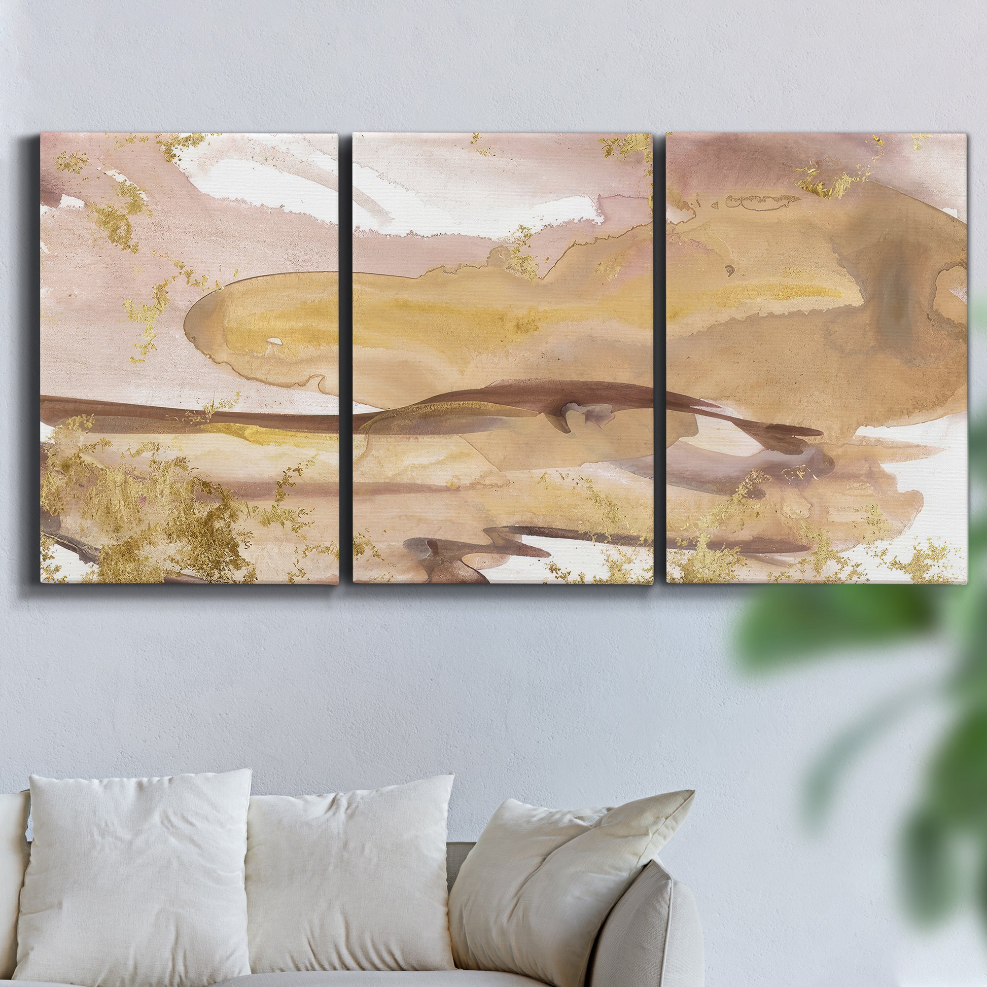 Three-panel canvas wall art featuring layered abstract dawn tones, displayed in a living room above a sofa.