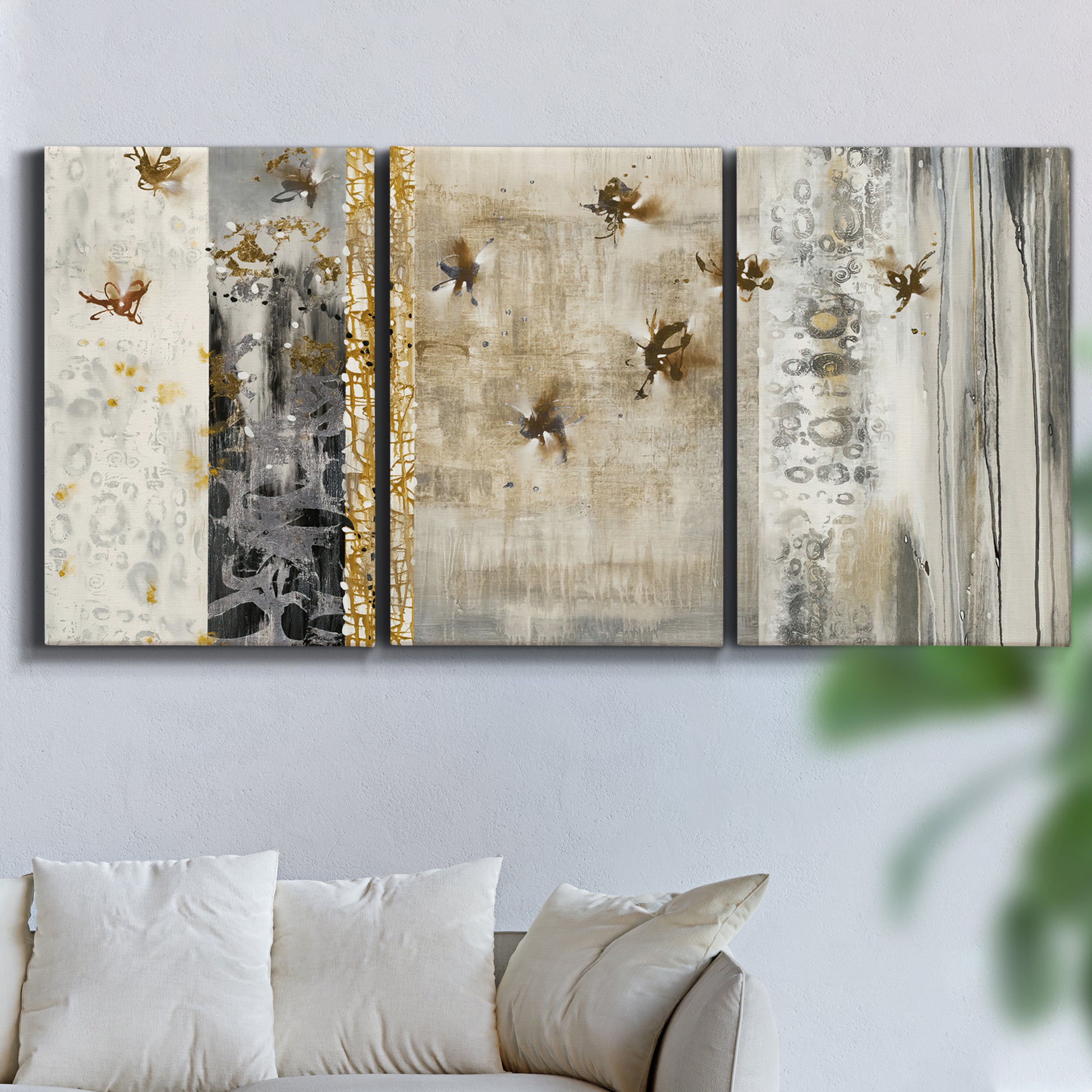 Three-panel canvas wall art featuring abstract willow inspired vertical forms, displayed in a living room above a sofa.