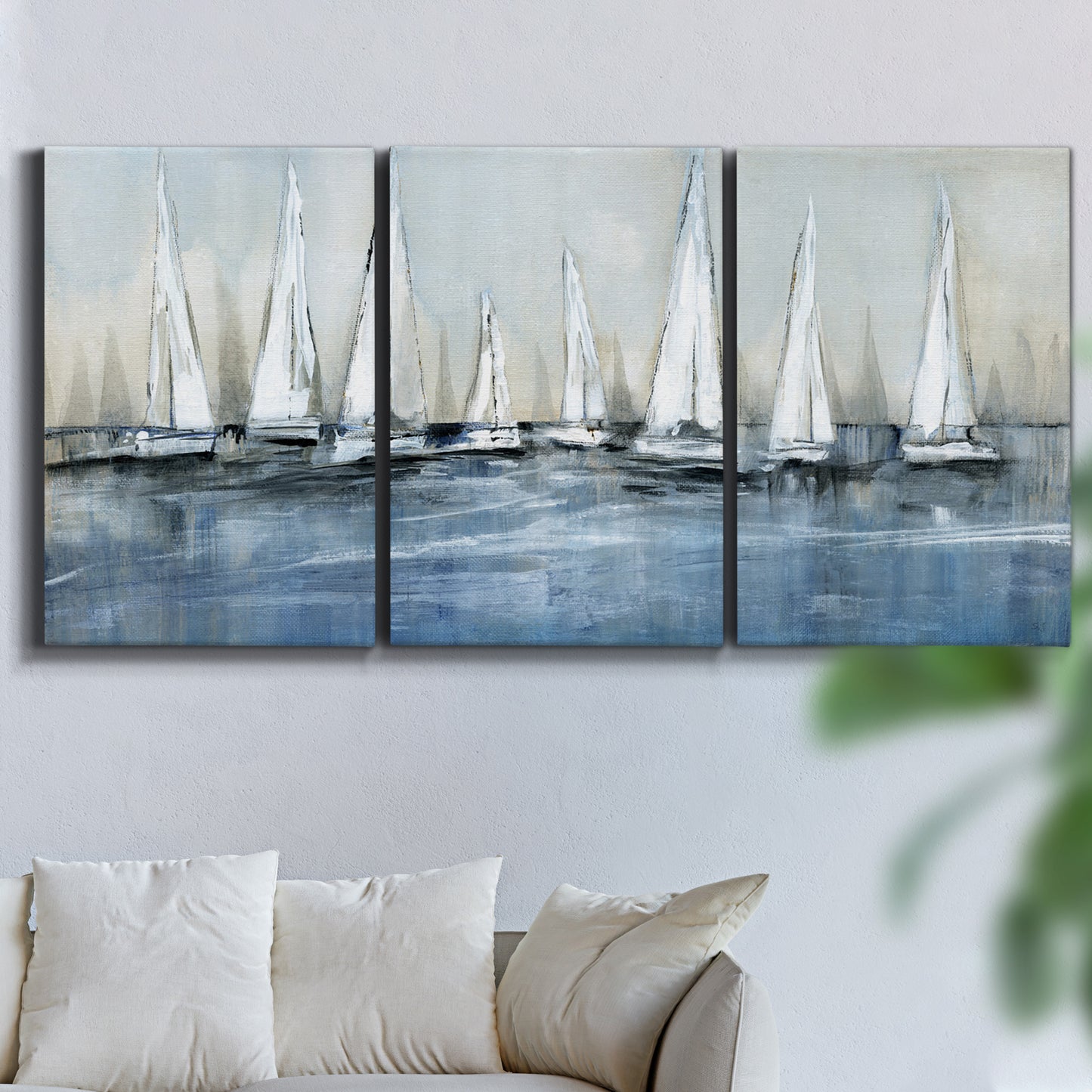 Three-panel canvas wall art featuring still life with pears and grapes, displayed in a living room above a sofa.