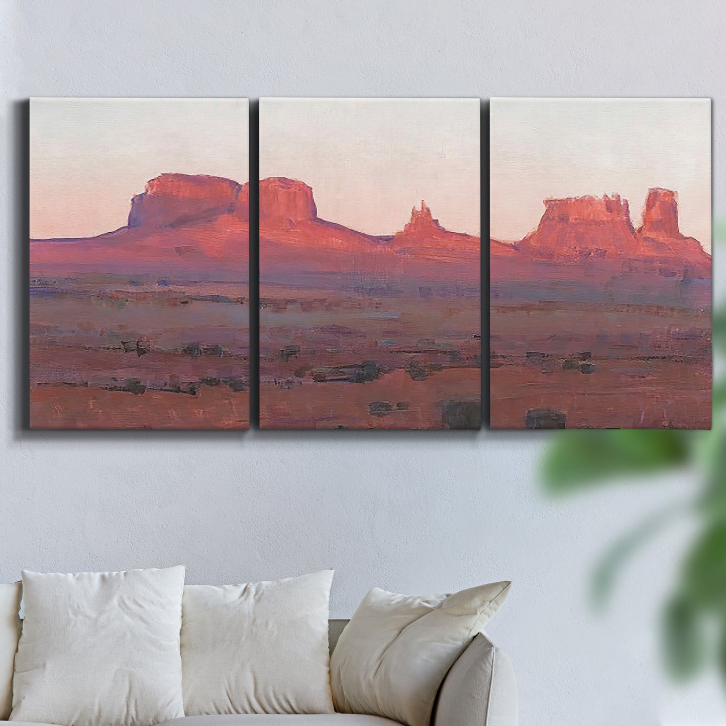 Three-panel canvas wall art featuring red rock desert formations at dusk, displayed in a living room above a sofa.