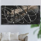 Three-panel canvas wall art featuring dark swirling abstract motion, displayed in a living room above a sofa.