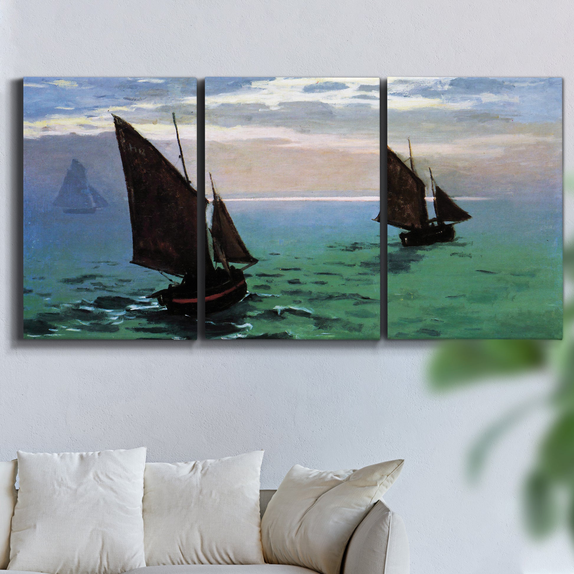 Three-panel canvas wall art featuring fishing boats moving through open sea, displayed in a living room above a sofa.