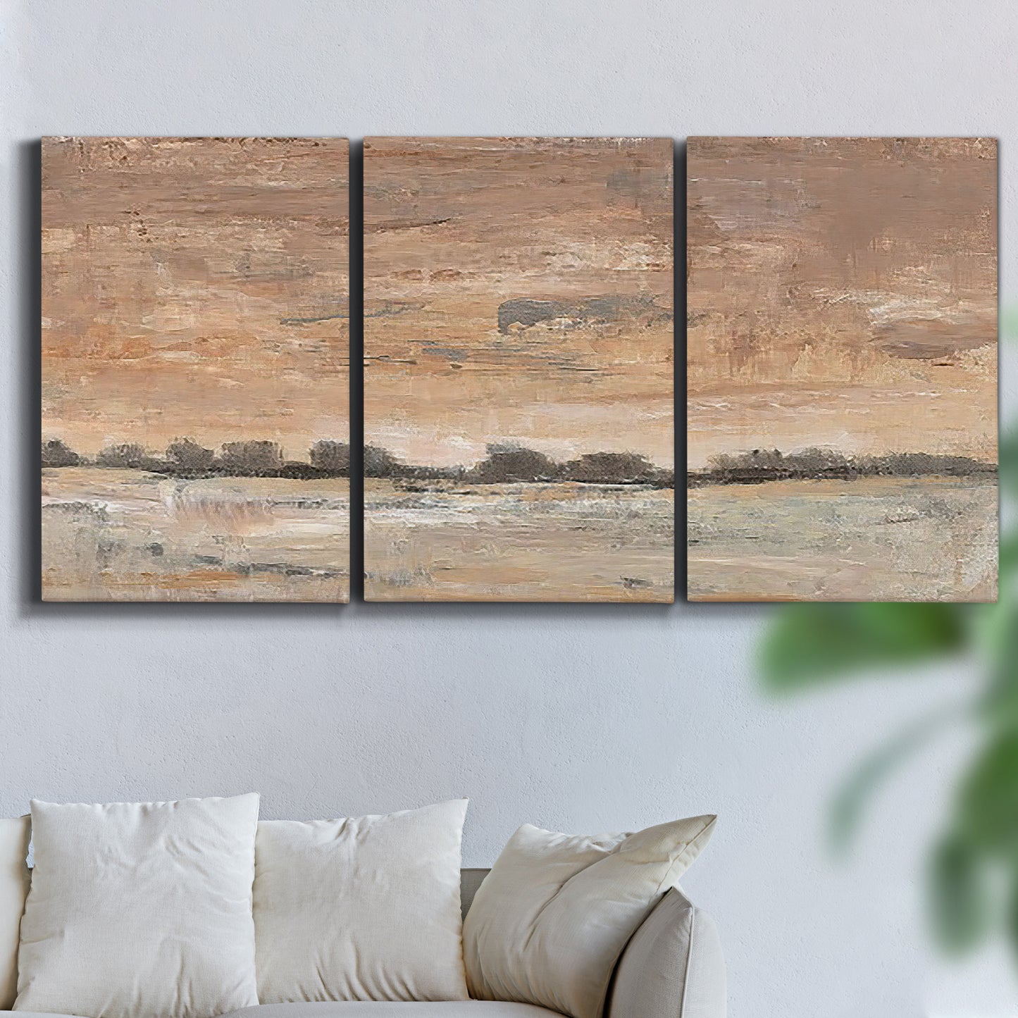 Three-panel canvas wall art featuring soft early evening landscape light, displayed in a living room above a sofa.