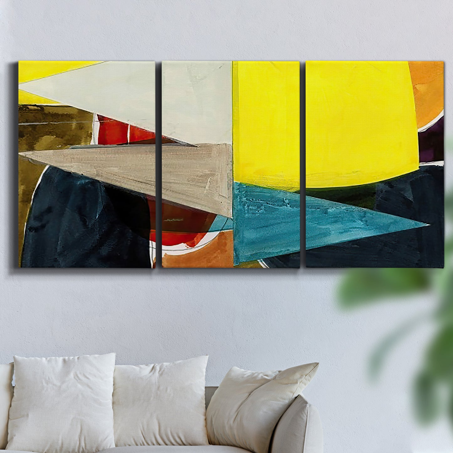 Three-panel canvas wall art featuring geometric mid century abstract blocks, displayed in a living room above a sofa.