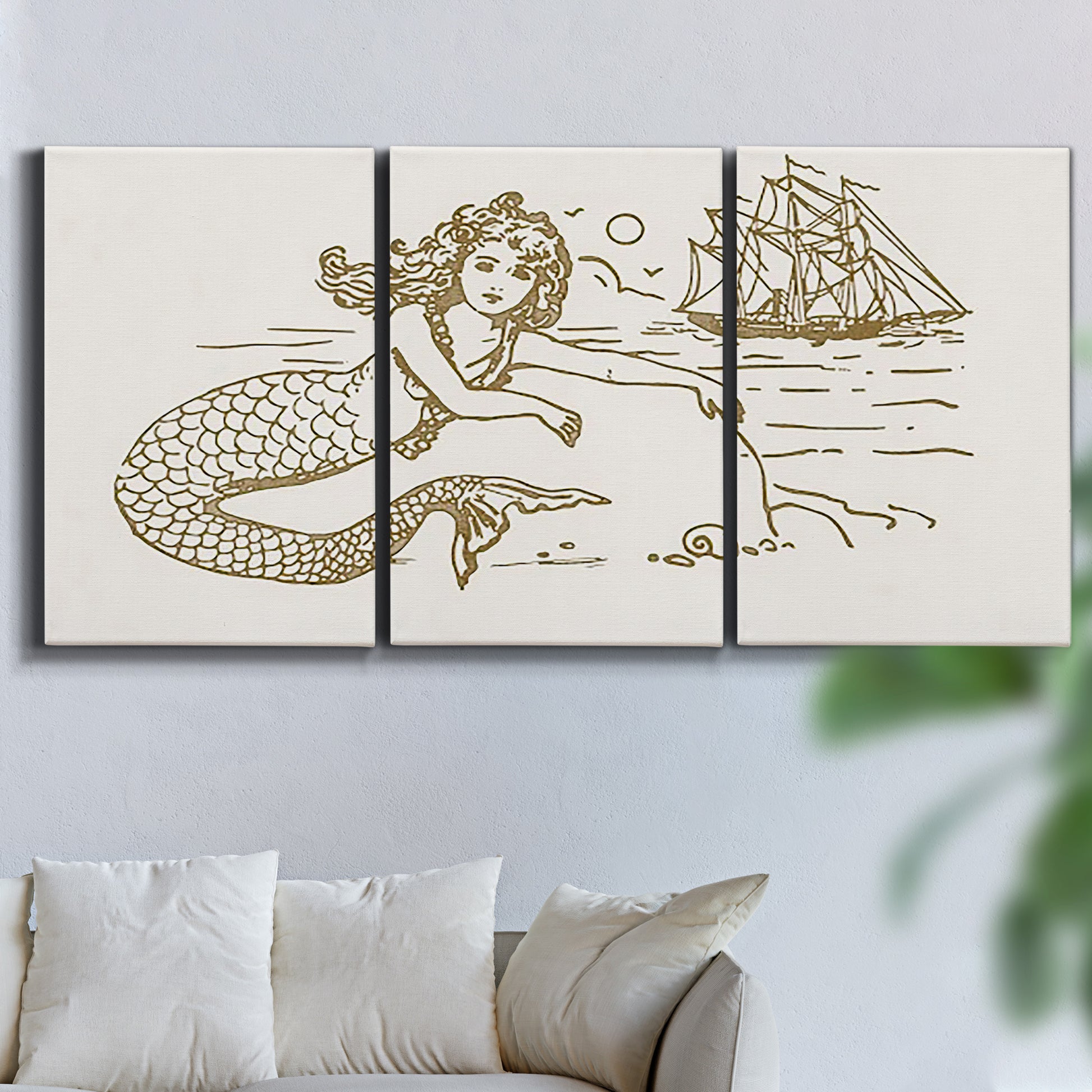 Three-panel canvas wall art featuring whimsical mermaid resting by sea, displayed in a living room above a sofa.