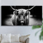 Three-panel canvas wall art featuring black and white cattle portrait, displayed in a living room above a sofa.