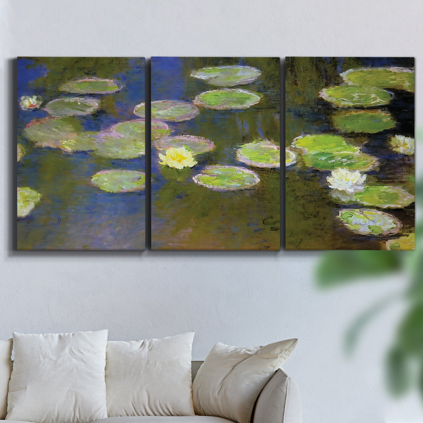 Three-panel canvas wall art featuring yellow and white water lilies, displayed in a living room above a sofa.