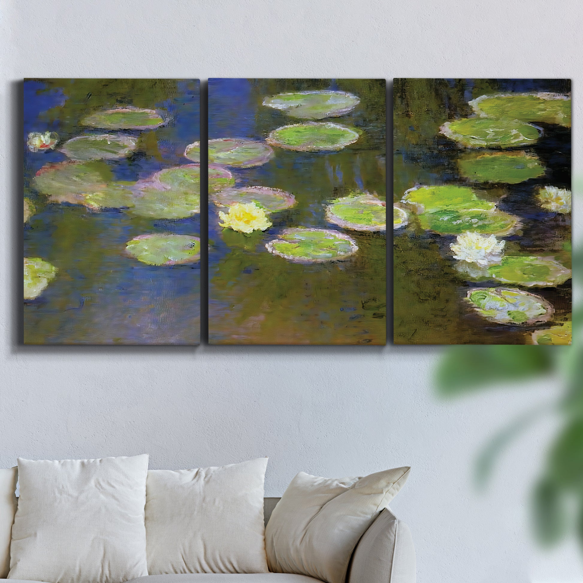 Three-panel canvas wall art featuring yellow and white water lilies, displayed in a living room above a sofa.