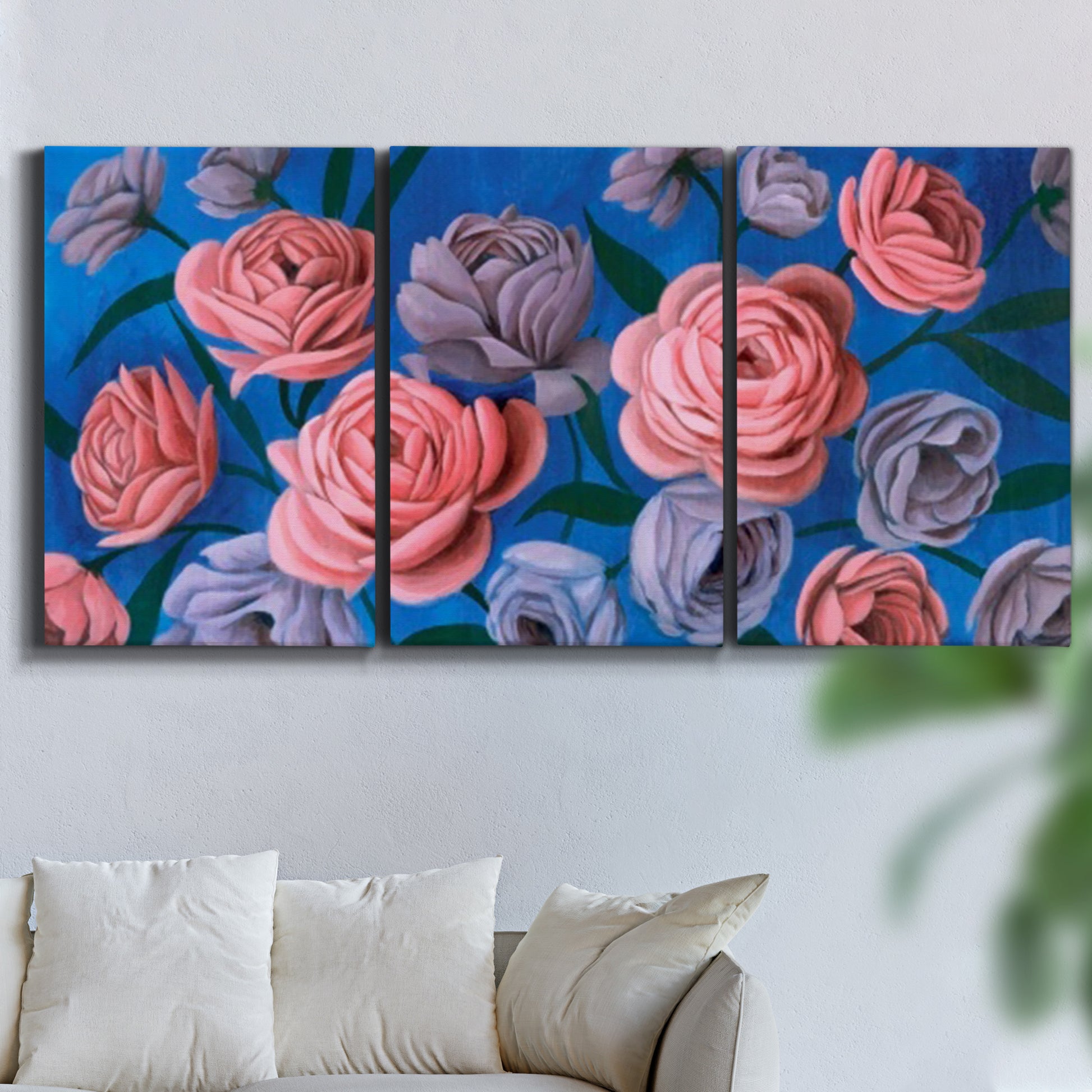 Three-panel canvas wall art featuring layered botanical petal abstractions, displayed in a living room above a sofa.