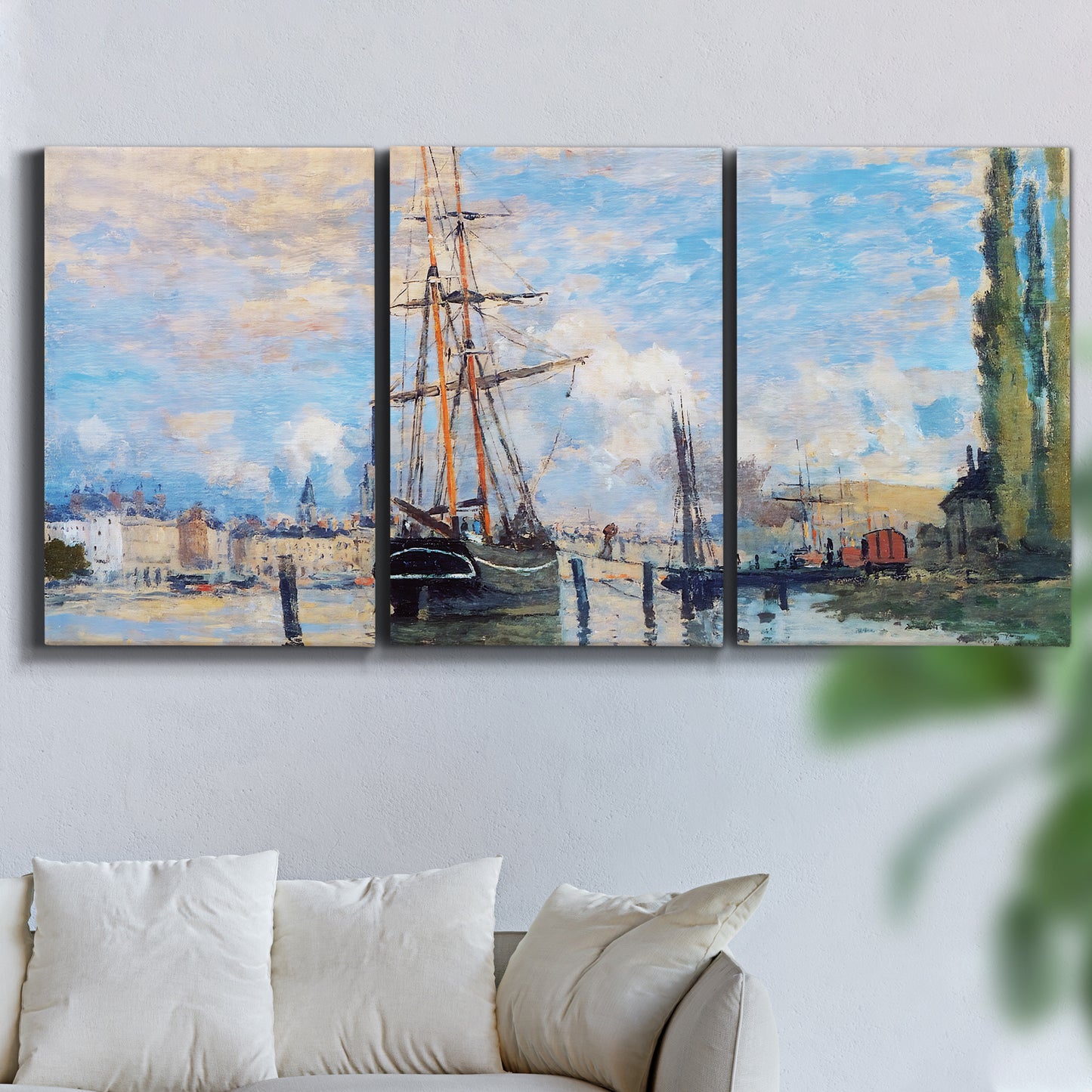 Three-panel canvas wall art featuring busy river port scene, displayed in a living room above a sofa.