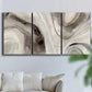 Three-panel canvas wall art featuring layered stone inspired abstract forms, displayed in a living room above a sofa.