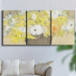 Three-panel canvas wall art featuring abstract floral table arrangement, displayed in a living room above a sofa.