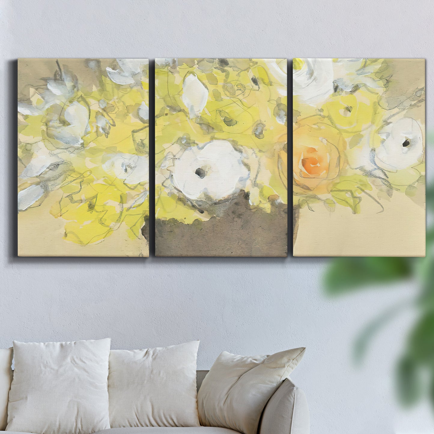 Three-panel canvas wall art featuring abstract floral table arrangement, displayed in a living room above a sofa.