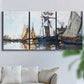 Three-panel canvas wall art featuring fishing boats navigating open water, displayed in a living room above a sofa.