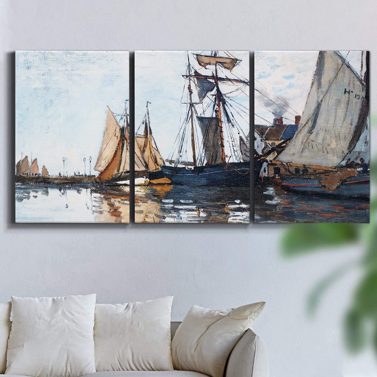 Three-panel canvas wall art featuring fishing boats navigating open water, displayed in a living room above a sofa.