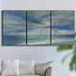 Three-panel canvas wall art featuring sunbeams breaking through coastal clouds, displayed in a living room above a sofa.