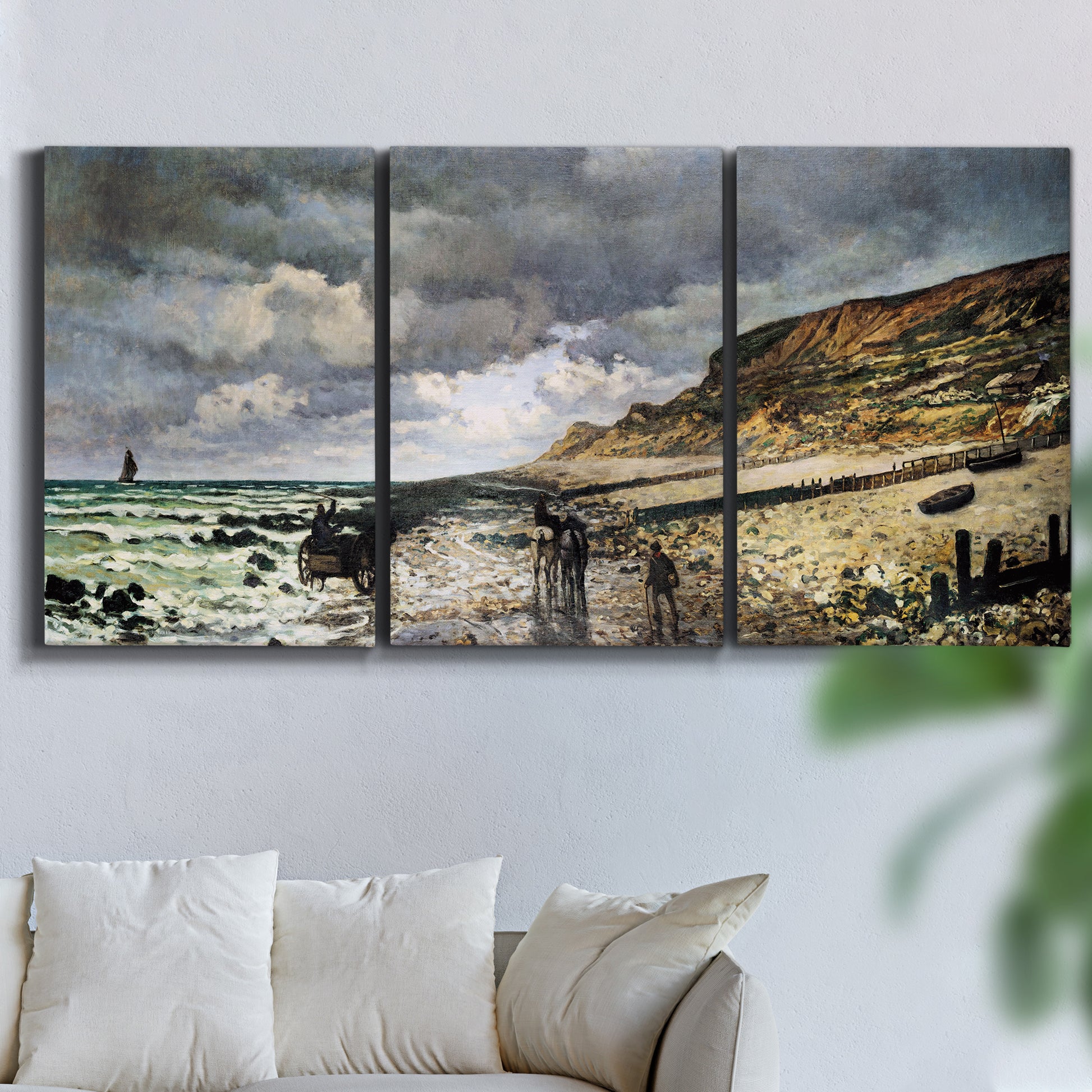 Three-panel canvas wall art featuring sunset beach with glowing sky, displayed in a living room above a sofa.