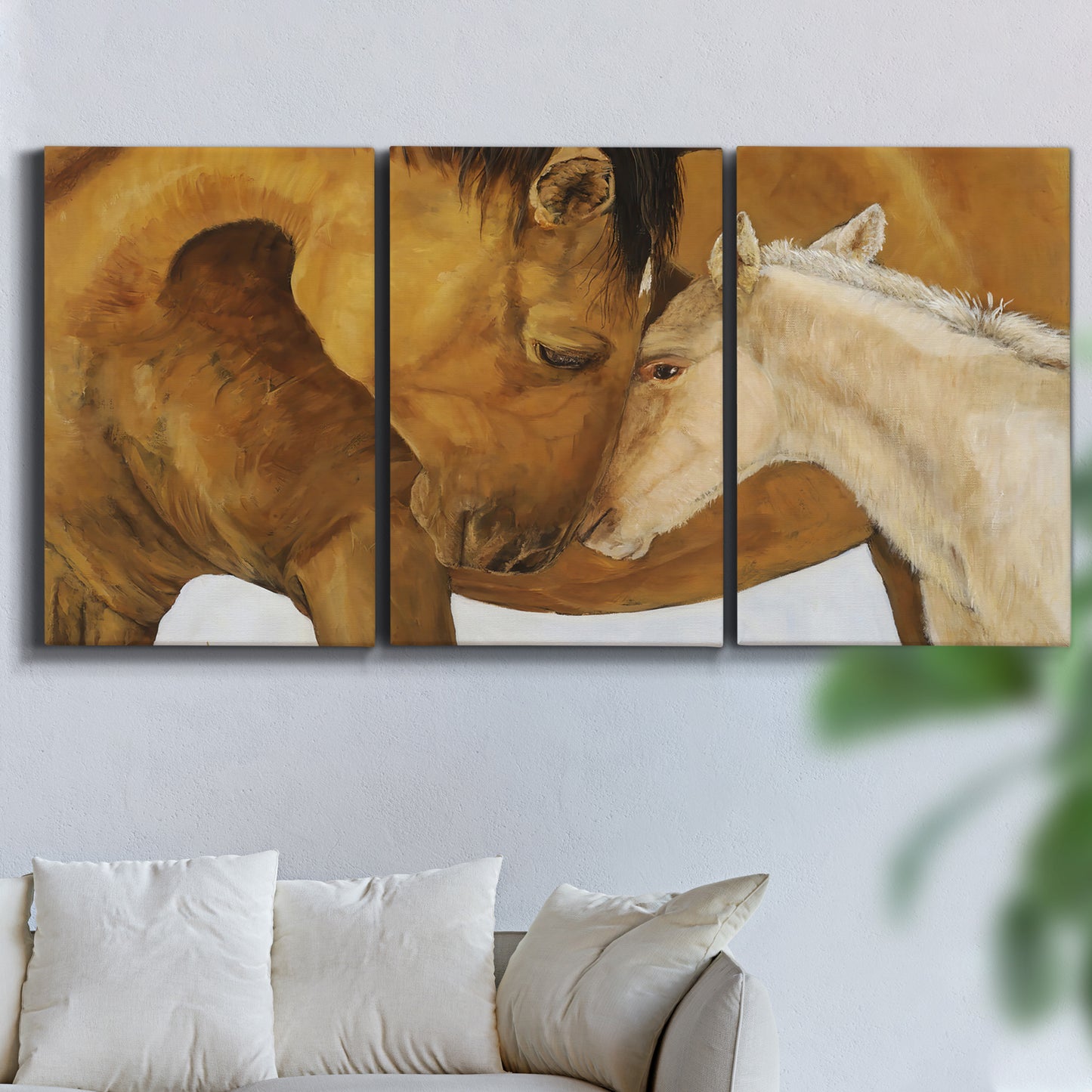 Three-panel canvas wall art featuring gentle horse portrait illustration, displayed in a living room above a sofa.