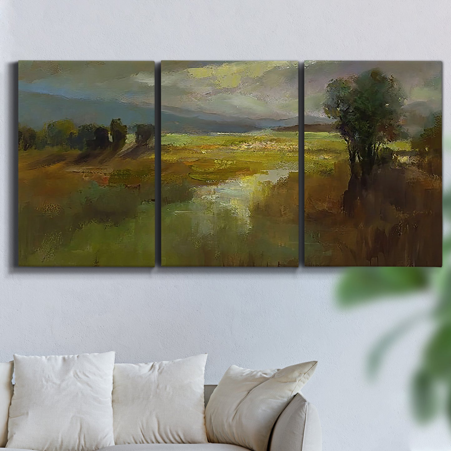 Three-panel canvas wall art featuring winding rural road through countryside, displayed in a living room above a sofa.