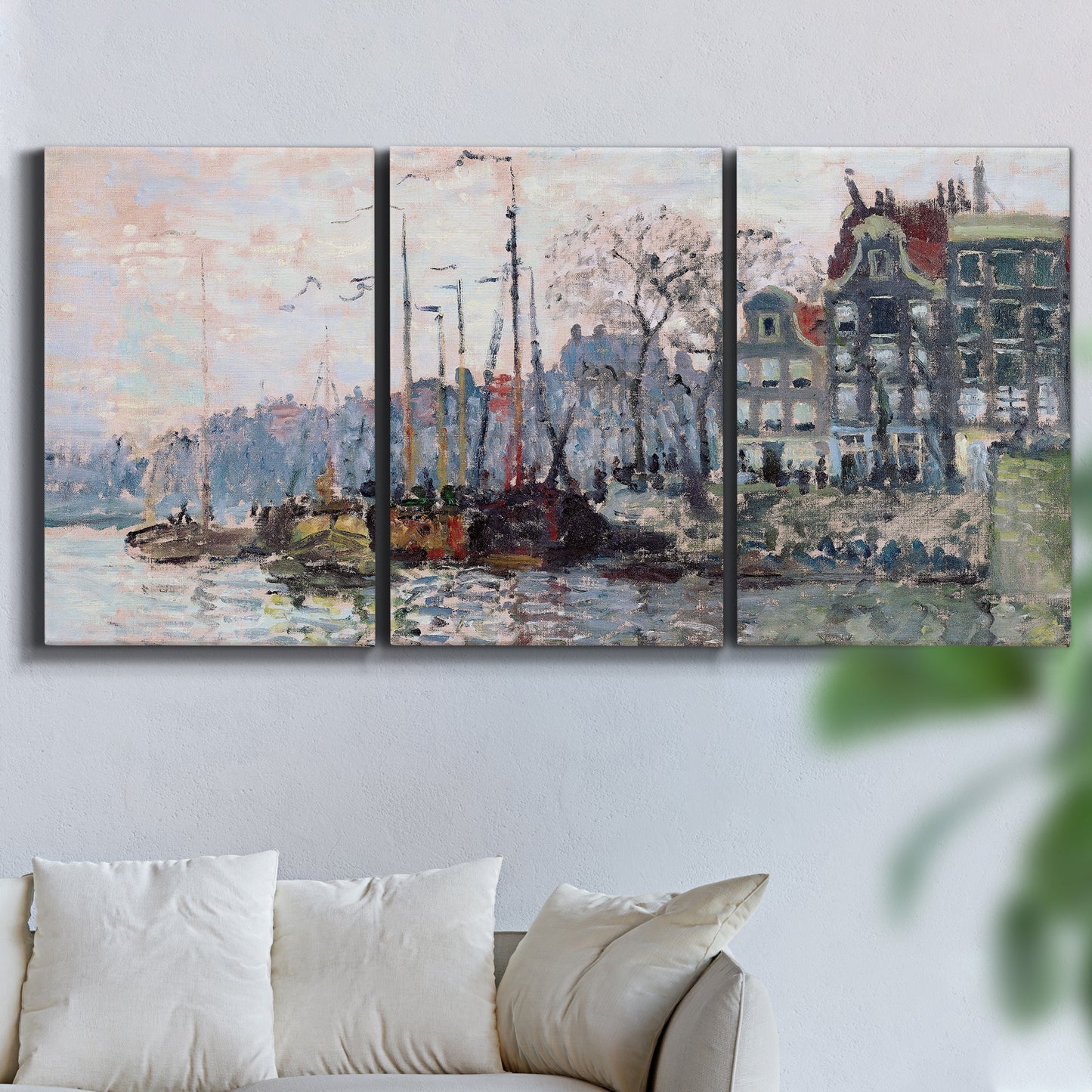 Three-panel canvas wall art featuring historic canal view with boats, displayed in a living room above a sofa.