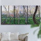 Three-panel canvas wall art featuring spring landscape along river, displayed in a living room above a sofa.