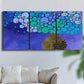 Three-panel canvas wall art featuring blue poppy floral abstraction, displayed in a living room above a sofa.