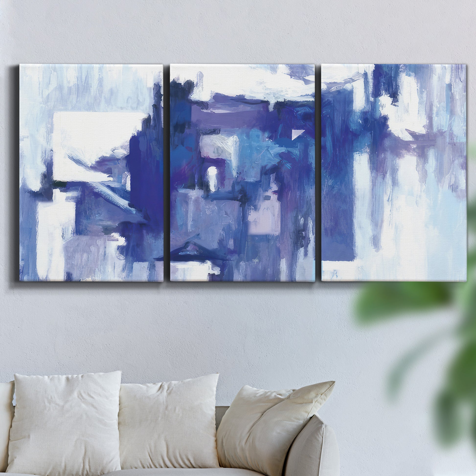 Three-panel canvas wall art featuring abstract urban street scene, displayed in a living room above a sofa.